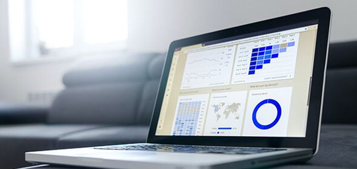 A laptop with several graphs on the screen